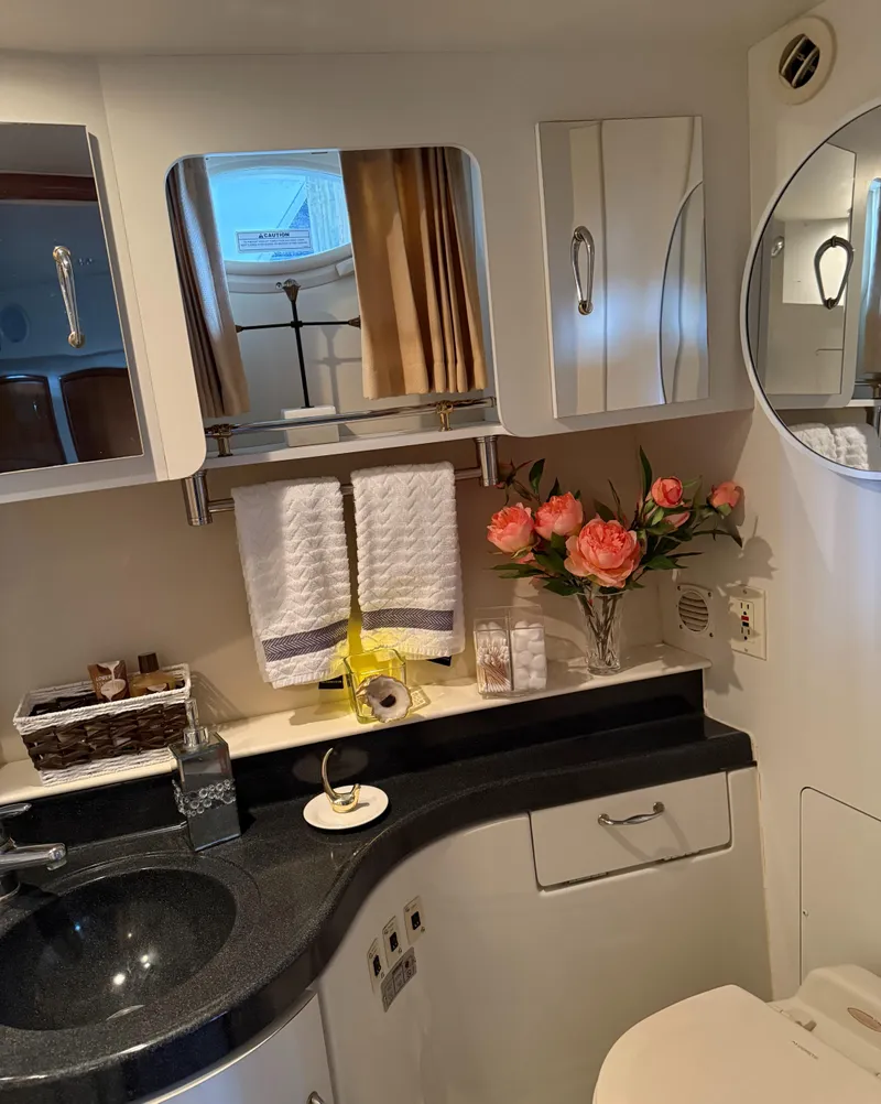 Slide: The Image of Luxurious bathroom in 2006 Carver 41 Cockpit Motor Yacht with elegant decor and floral arrangement. - 20