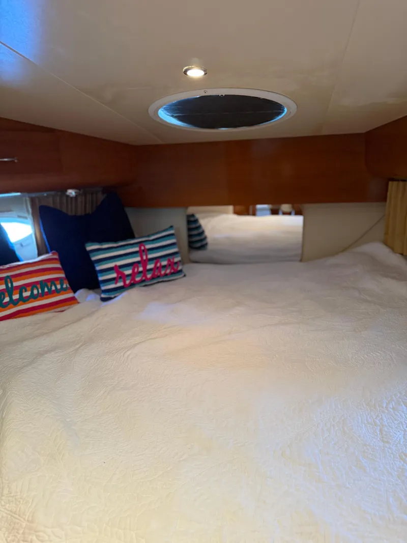 Slide: The Image of Cozy cabin interior of 2006 Carver 41 Cockpit Motor Yacht with decorative pillows. - 24