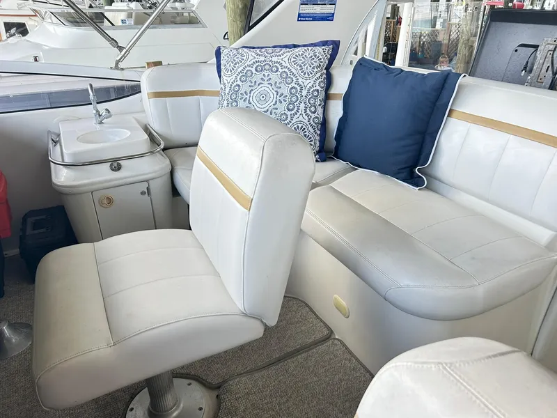 Slide: The Image of Interior of 2006 Carver 41 Cockpit Motor Yacht with white seating and decorative pillows. - 32