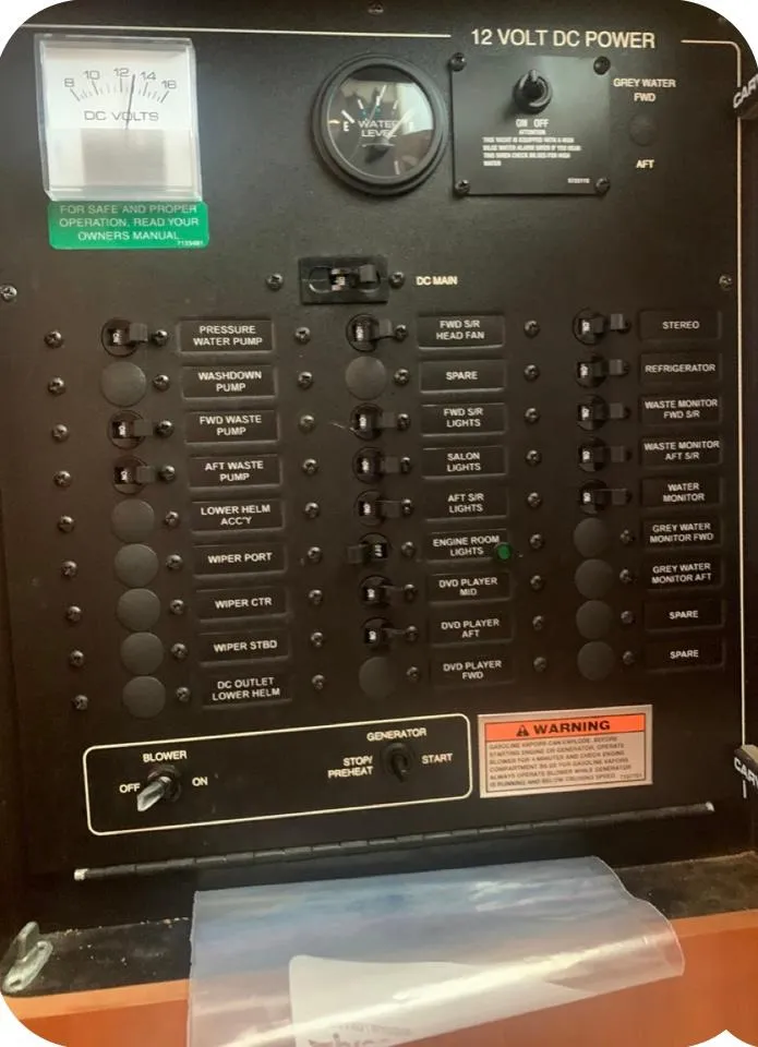 Slide: The Image of Control panel of a 2006 Carver 41 Cockpit Motor Yacht, showing 12-volt DC power switches. - 36