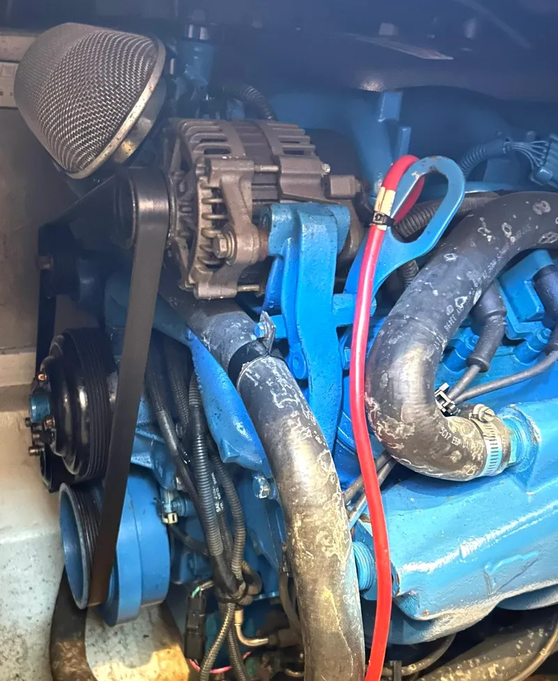 Slide: The Image of Engine compartment of a 2006 Carver 41 Cockpit Motor Yacht, featuring blue components and wiring. - 39