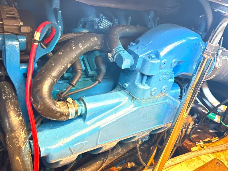 Slide: The Image of Engine compartment of a 2006 Carver 41 Cockpit Motor Yacht, featuring blue components and hoses. - 40