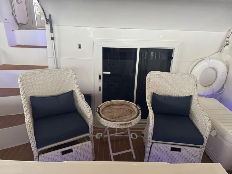Slide: The Image of 2006 Carver 41 Cockpit Motor Yacht interior with wicker chairs and table. - 5