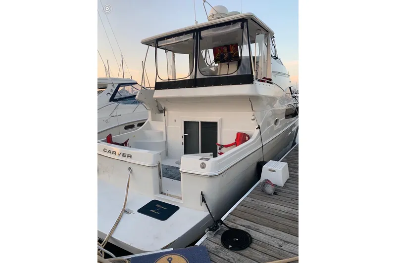 Slide: The Image of 2006 Carver 41 Cockpit Motor Yacht docked at marina, rear view. - 54