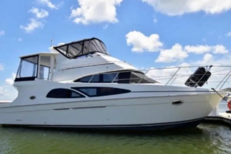 Slide: The Image of 2006 Carver 41 Cockpit Motor Yacht docked under a clear blue sky. - 56