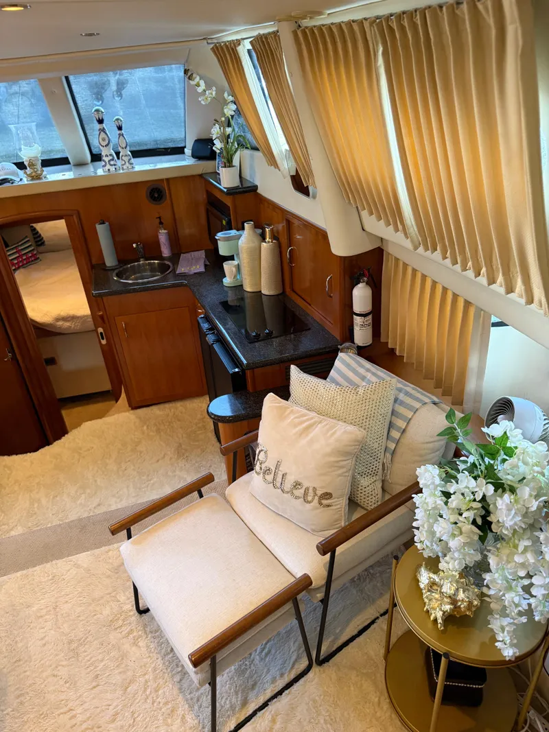 Slide: The Image of Interior of 2006 Carver 41 Cockpit Motor Yacht with cozy seating and elegant decor. - 8
