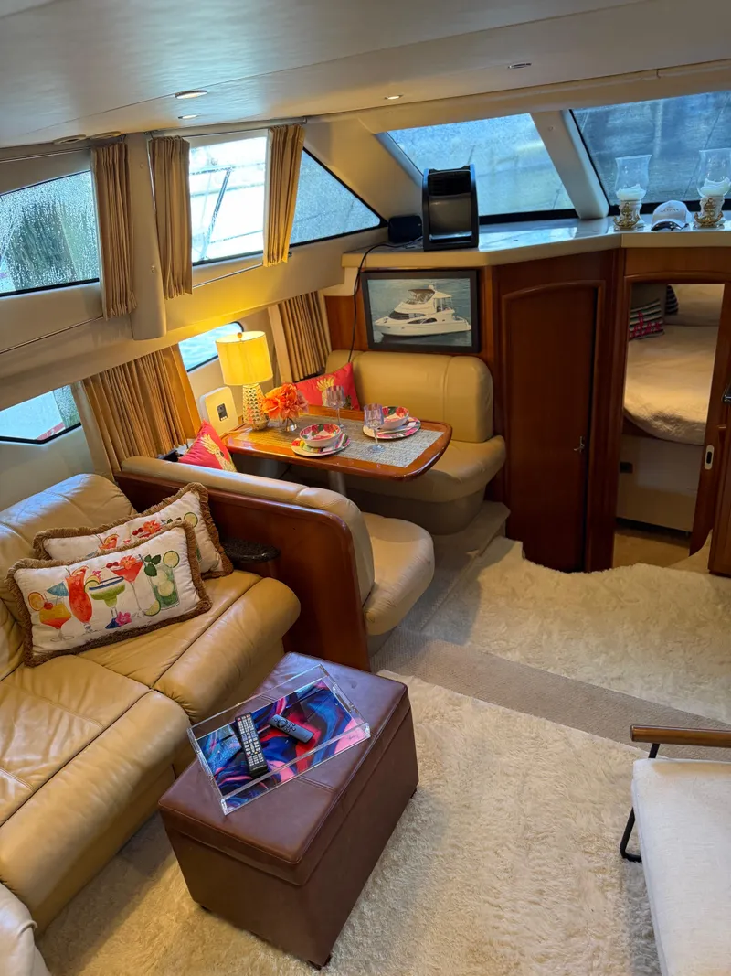 Slide: The Image of Luxurious interior of a 2006 Carver 41 Cockpit Motor Yacht with cozy seating and decor. - 9