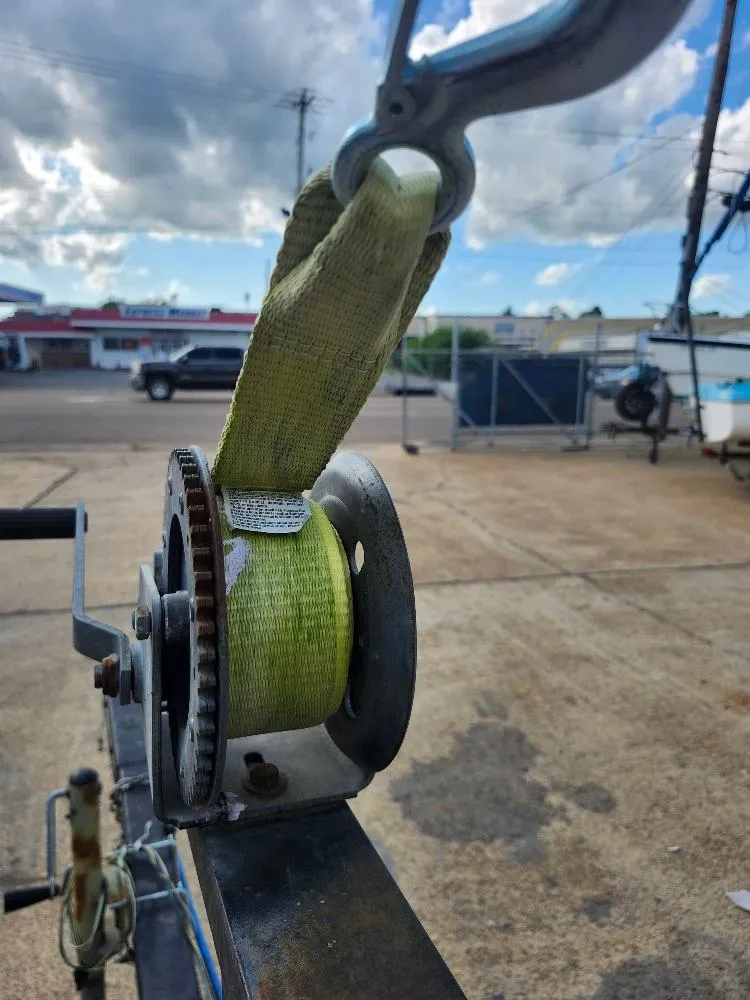 Slide: The Image of Close-up of a winch with a green strap on a Hunter 23, 1988 model. - 11
