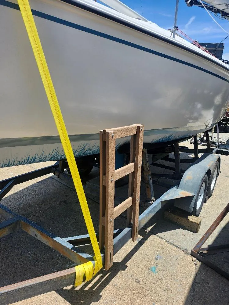 Slide: The Image of 1988 Hunter 23 sailboat on trailer with ladder and yellow strap. - 17