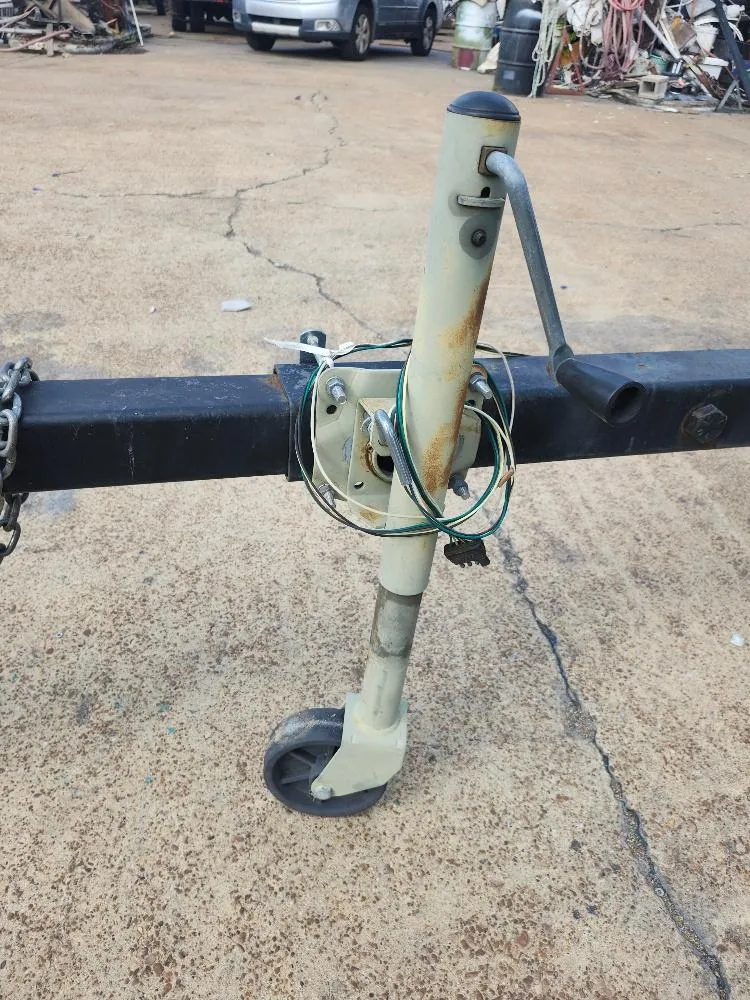 Slide: The Image of Trailer jack with wheel and handle, Hunter 23, 1988 model, on concrete surface. - 18