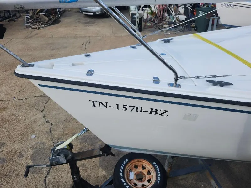 Slide: The Image of 1988 Hunter 23 sailboat on trailer, registration TN-1570-BZ, parked on concrete surface. - 8