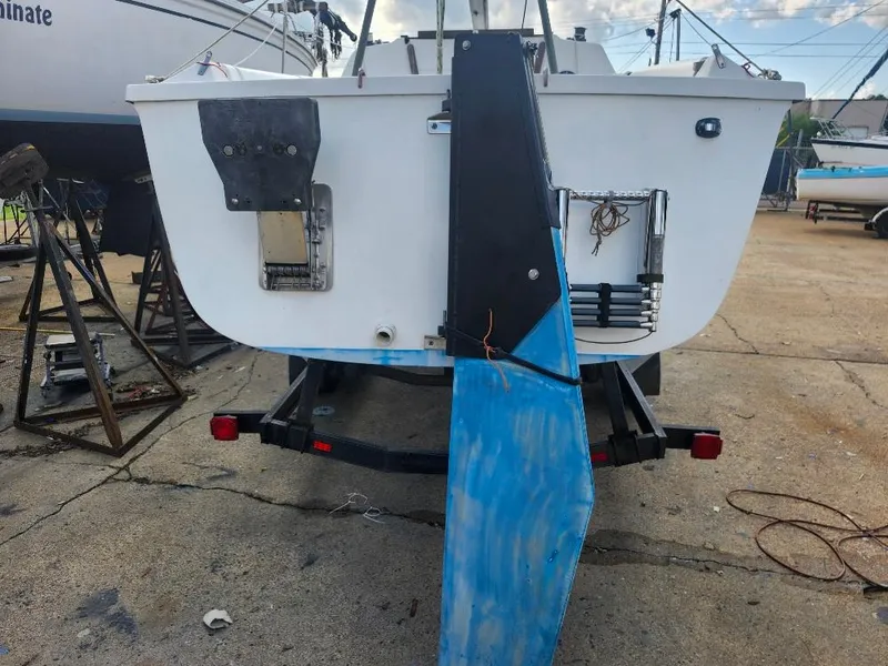 Slide: The Image of 1988 Hunter 23 sailboat on trailer, showing stern and rudder in a boatyard. - 9