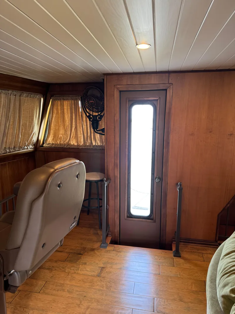 Slide: The Image of Interior of a 2003 custom houseboat with wood paneling and seating. - 12