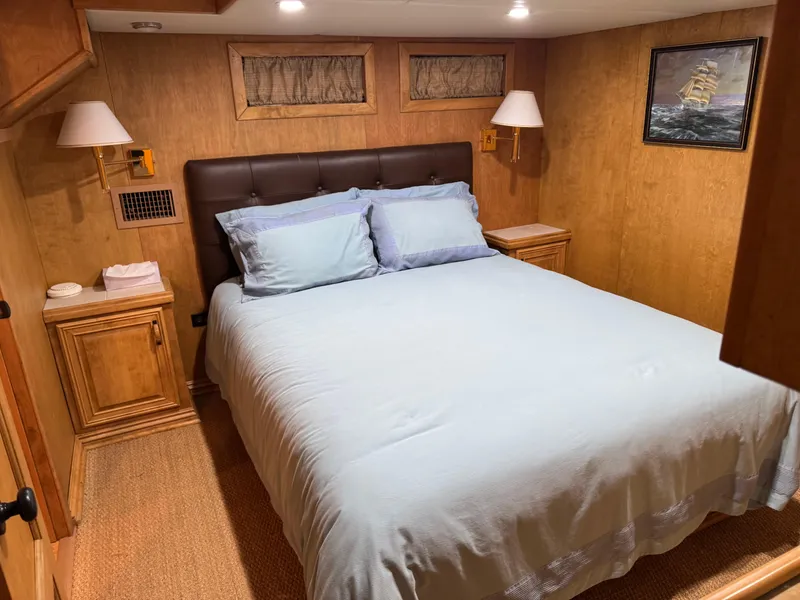 Slide: The Image of Cozy bedroom in a 2003 custom houseboat with wooden decor and nautical artwork. - 18