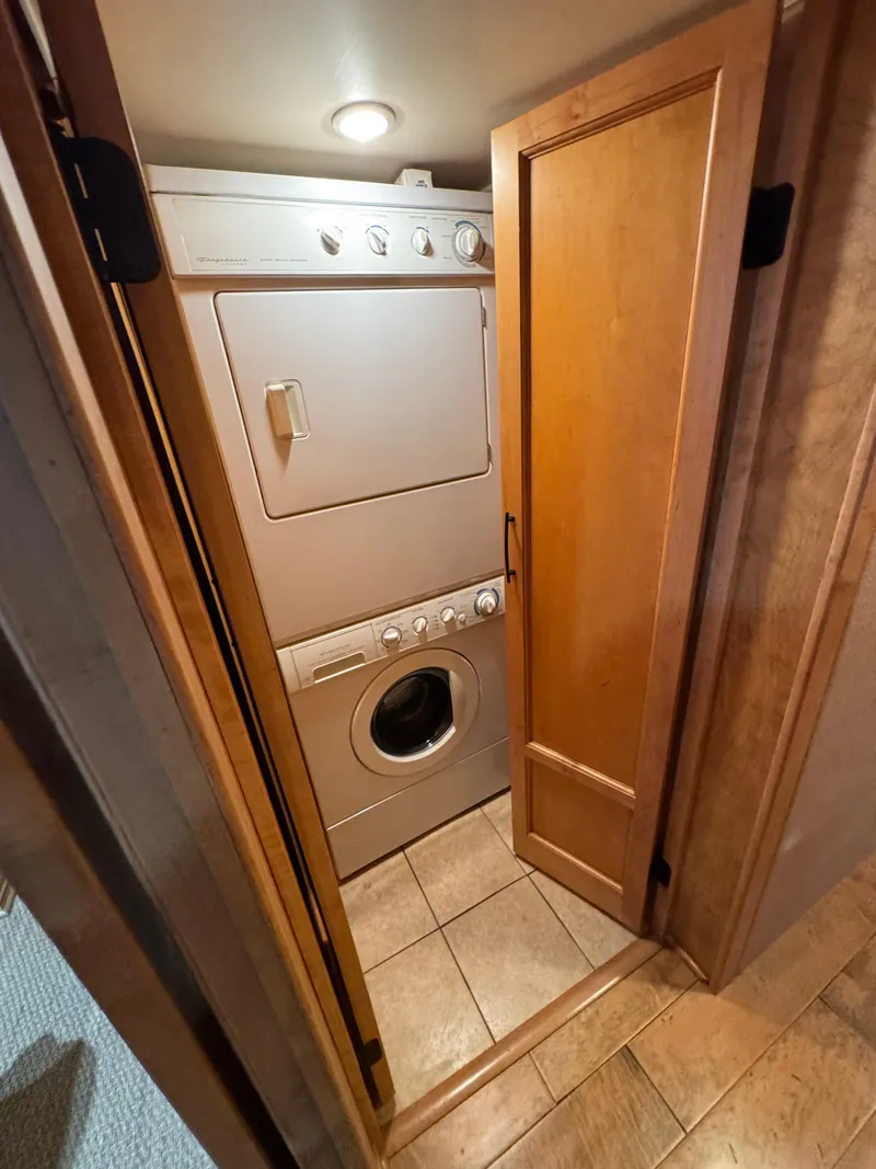 Slide: The Image of Stacked washer and dryer in a 2003 custom houseboat laundry area. - 21