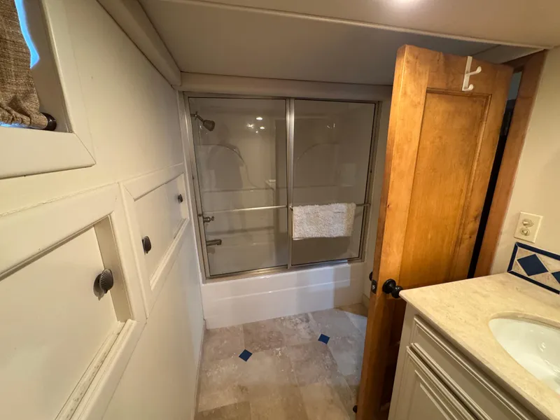 Slide: The Image of Houseboat bathroom with shower, wooden door, and storage cabinets, 2003 custom model. - 23