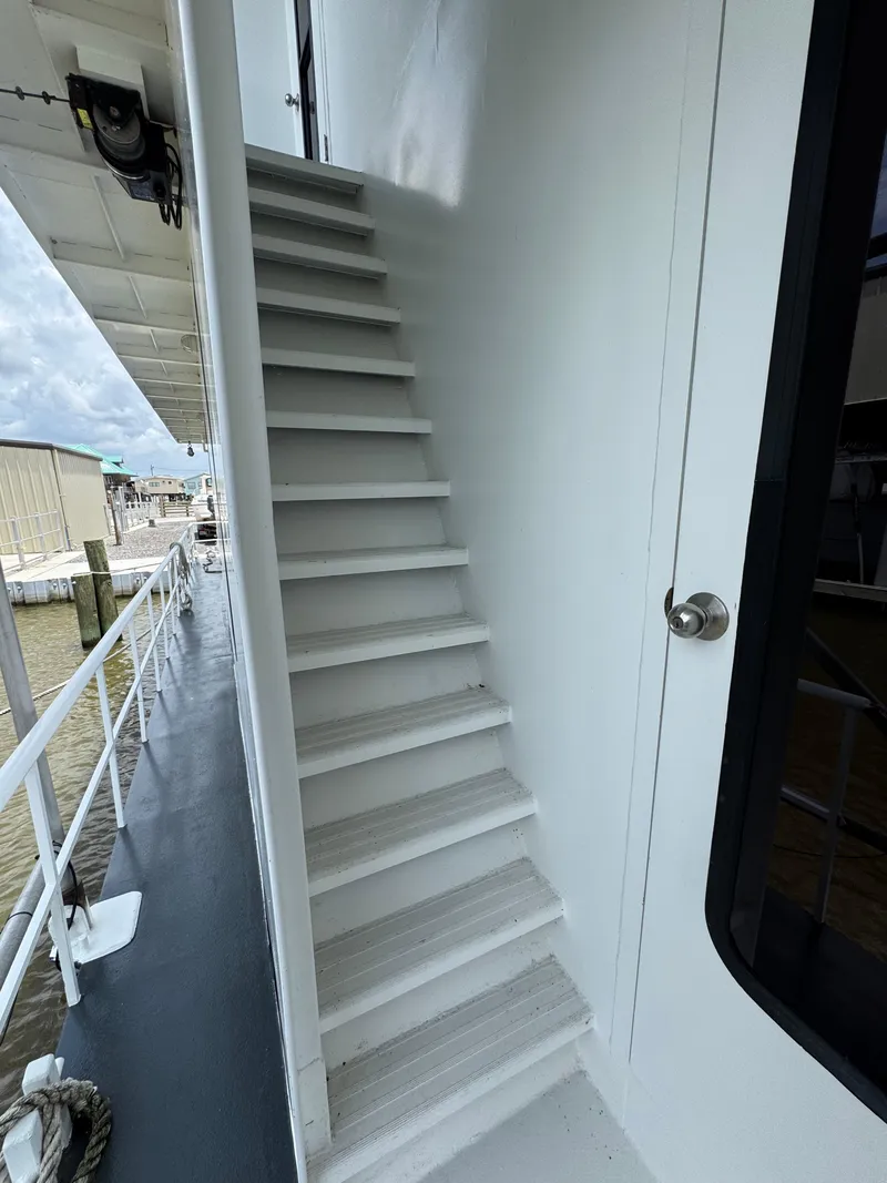 Slide: The Image of Staircase on a 2003 custom houseboat, leading to upper deck, dockside view. - 28
