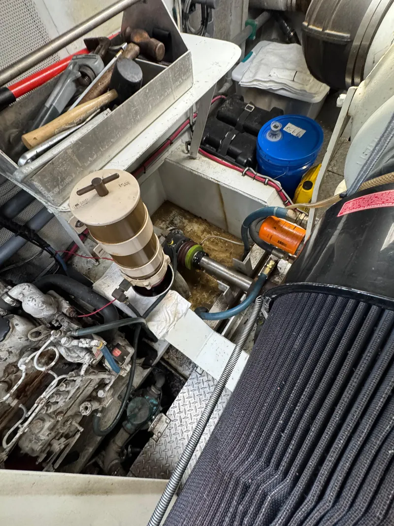 Slide: The Image of Engine room of a 2003 custom houseboat with tools and mechanical components. - 30