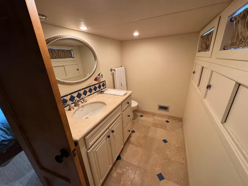 Slide: The Image of Luxurious houseboat bathroom with elegant vanity, mirror, and tiled floor, 2003 custom model. - 32