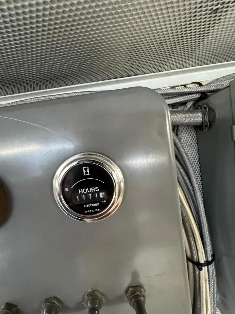 Slide: The Image of Hour meter on a 2003 custom houseboat dashboard, displaying usage hours. - 34