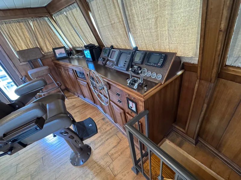 Slide: The Image of Control room of a 2003 custom houseboat with wooden interior and navigation equipment. - 37
