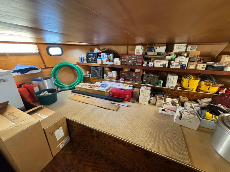 Slide: The Image of Interior of a 2003 custom houseboat with organized storage and various supplies. - 38