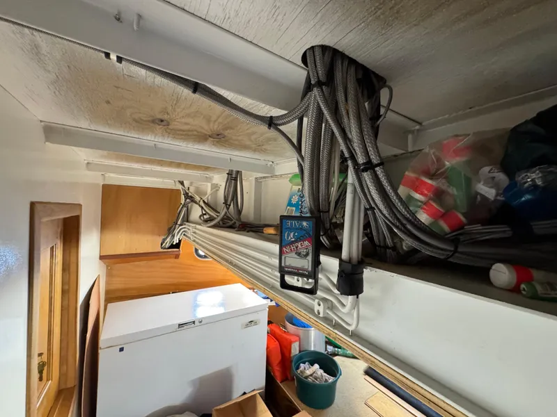Slide: The Image of Interior of a 2003 custom houseboat with cables and storage items. - 41