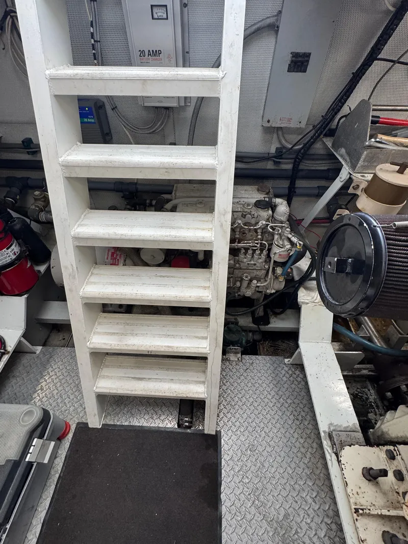 Slide: The Image of Engine room of a 2003 custom houseboat with ladder and machinery. - 43