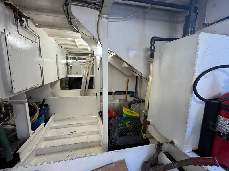 Slide: The Image of Interior of a 2003 custom houseboat showing utility area with equipment and storage. - 44