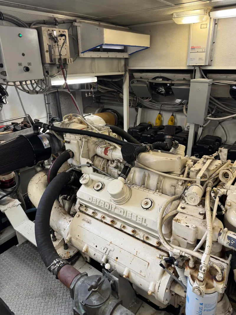 Slide: The Image of Engine room of a 2003 custom houseboat featuring a Detroit Diesel engine. - 49