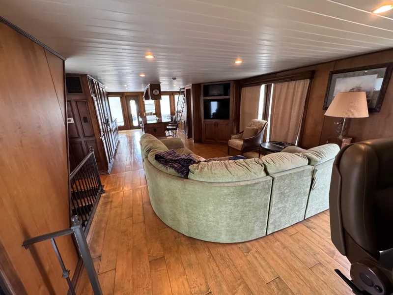 Slide: The Image of Luxurious 2003 custom houseboat interior with cozy seating, wood paneling, and modern amenities. - 6