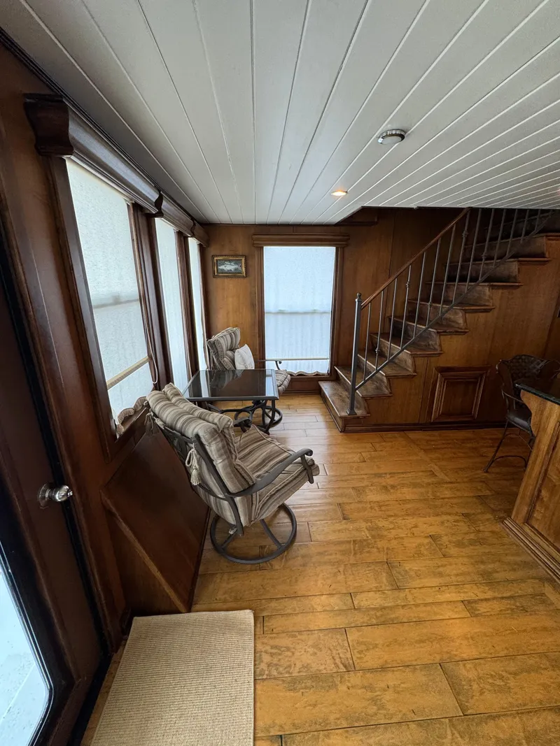 Slide: The Image of Interior of a 2003 custom houseboat with wooden floors and staircase. - 9
