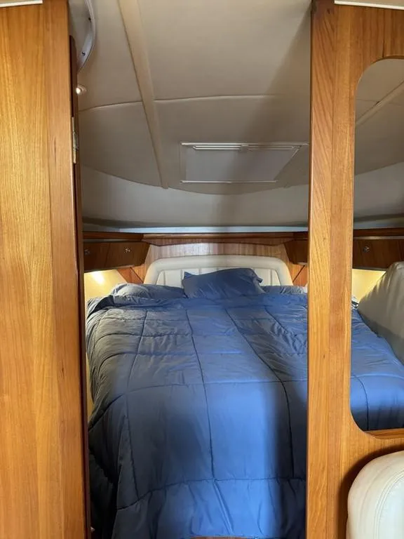 Slide: The Image of Luxurious cabin interior of 2004 Tiara Yachts 3600 Sovran with blue bedding. - 18