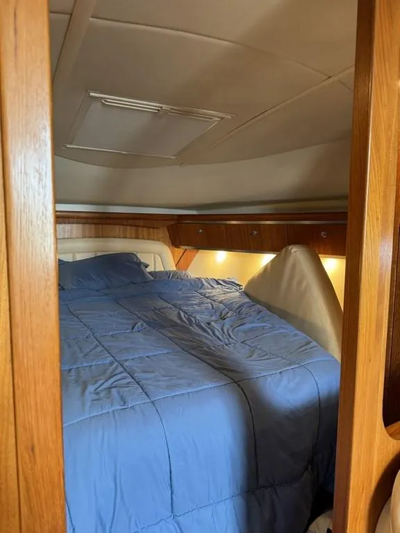 Slide: The Image of Cozy cabin interior of 2004 Tiara Yachts 3600 Sovran with blue bedding. - 19