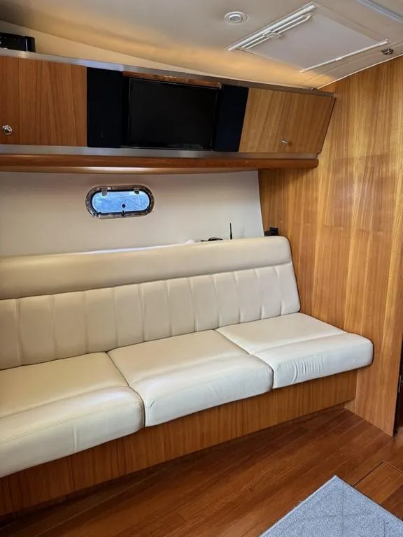Slide: The Image of 2004 Tiara Yachts 3600 Sovran interior with leather seating and wooden cabinetry. - 27