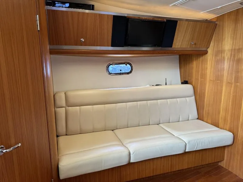 Slide: The Image of Interior of 2004 Tiara Yachts 3600 Sovran with beige seating and wooden cabinetry. - 28