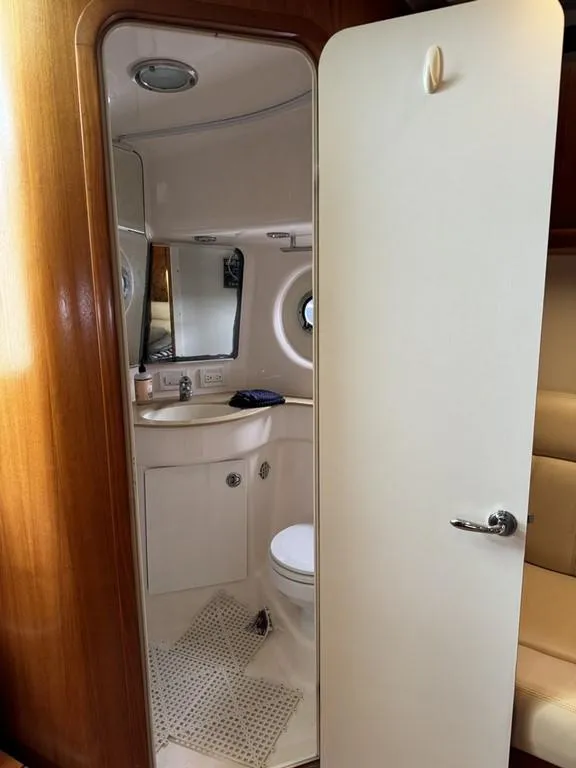 Slide: The Image of 2004 Tiara Yachts 3600 Sovran bathroom with sink, mirror, and porthole window. - 29