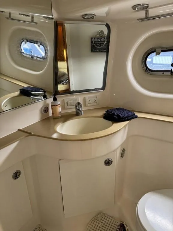 Slide: The Image of Bathroom interior of 2004 Tiara Yachts 3600 Sovran with sink and porthole window. - 31
