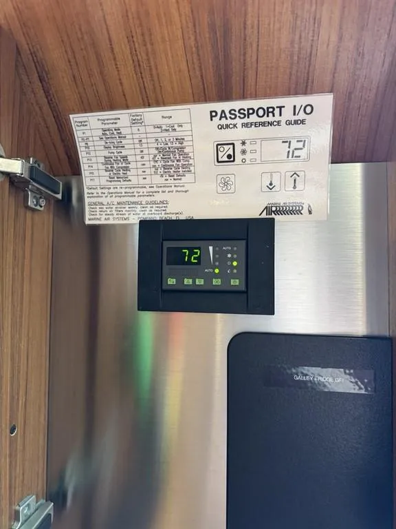 Slide: The Image of Control panel inside 2004 Tiara Yachts 3600 Sovran, displaying temperature settings and quick reference guide. - 35