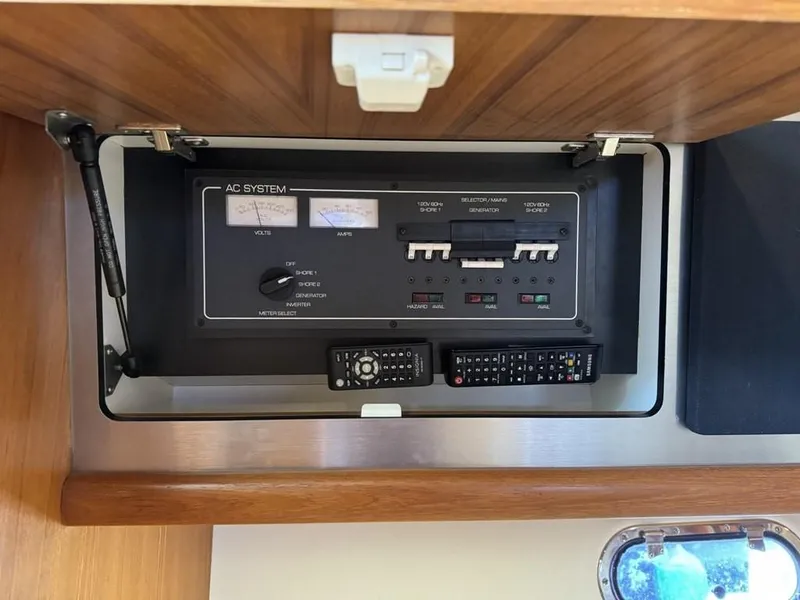 Slide: The Image of AC system panel on 2004 Tiara Yachts 3600 Sovran, featuring controls and meters. - 39
