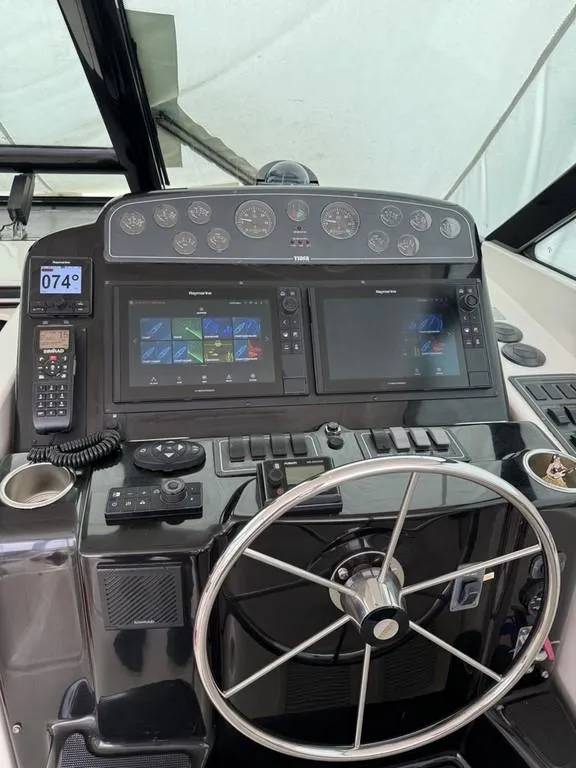 Slide: The Image of Helm of 2004 Tiara Yachts 3600 Sovran with dual navigation screens and steering wheel. - 4
