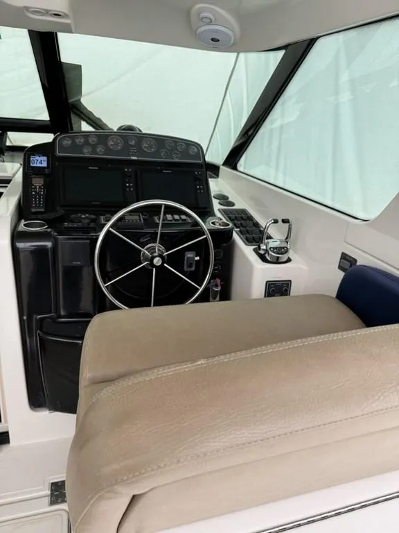 Slide: The Image of 2004 Tiara Yachts 3600 Sovran helm with steering wheel and navigation controls. - 6