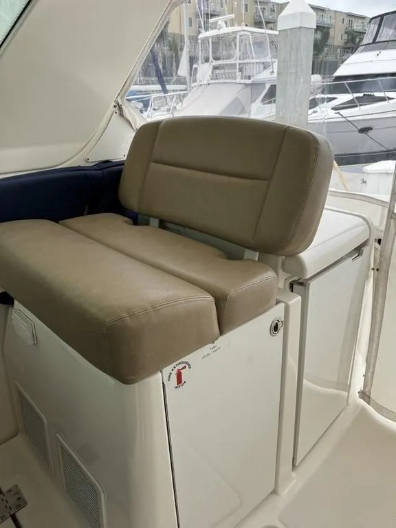Slide: The Image of 2004 Tiara Yachts 3600 Sovran interior seating with beige cushions, docked at marina. - 9