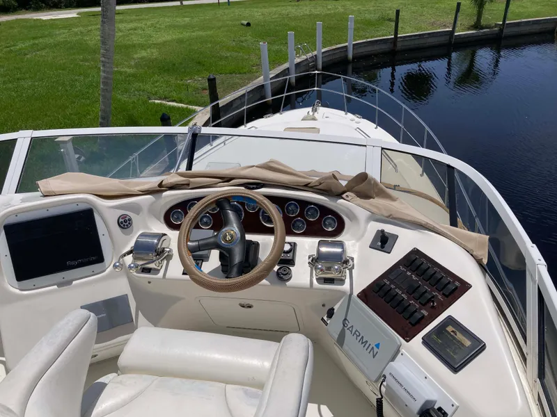 Slide: The Image of 2004 Sea Ray 400 Bridge Deck helm with steering wheel and navigation equipment. - 10
