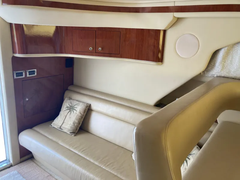 Slide: The Image of Interior of 2004 Sea Ray 400 Bridge Deck with beige leather seating and wood accents. - 18
