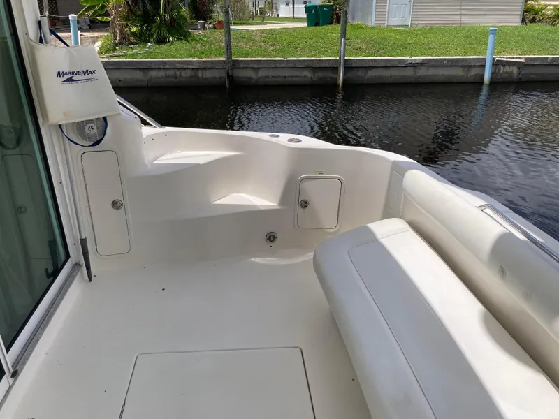 Slide: The Image of 2004 Sea Ray 400 Bridge Deck boat interior with seating and water view. - 5