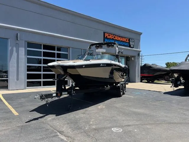 Slide: The Image of 2022 MasterCraft XStar S boat on trailer outside dealership. - 1