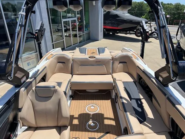 Slide: The Image of 2022 MasterCraft XStar S boat interior with tan seating and teak flooring. - 10