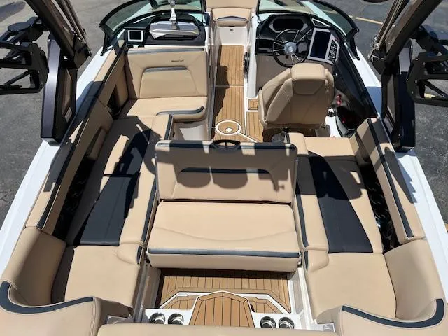 Slide: The Image of 2022 MasterCraft XStar S boat interior with luxurious seating and modern dashboard. - 12