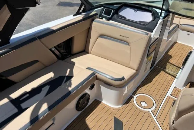 Slide: The Image of 2022 MasterCraft XStar S interior with tan seating and teak flooring. - 17